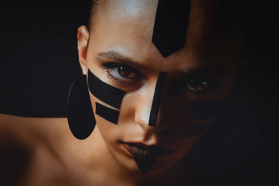 Collection of costume makeup tools and colorful palettes on a creative workspace