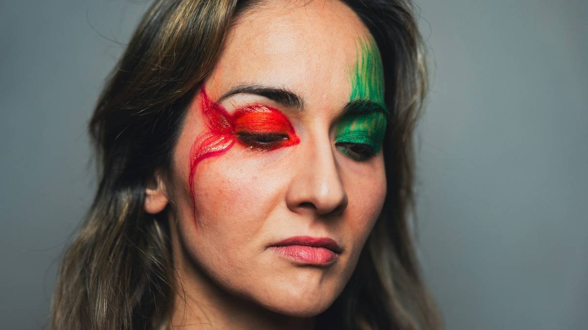 Model applying party makeup for photos with professional lighting setup