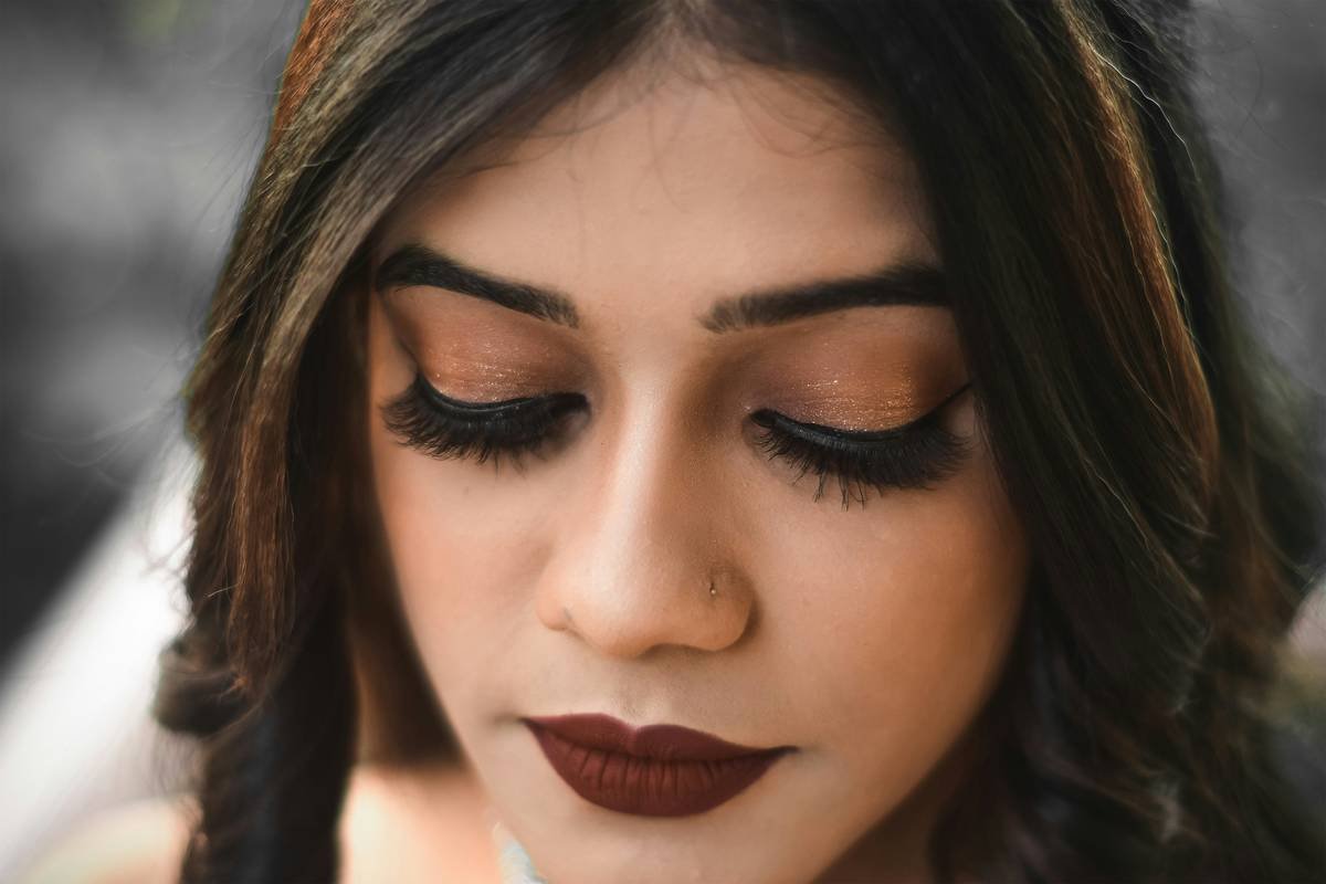 Vibrant party makeup for women featuring bold eyeshadow and glitter accents on diverse skin tones